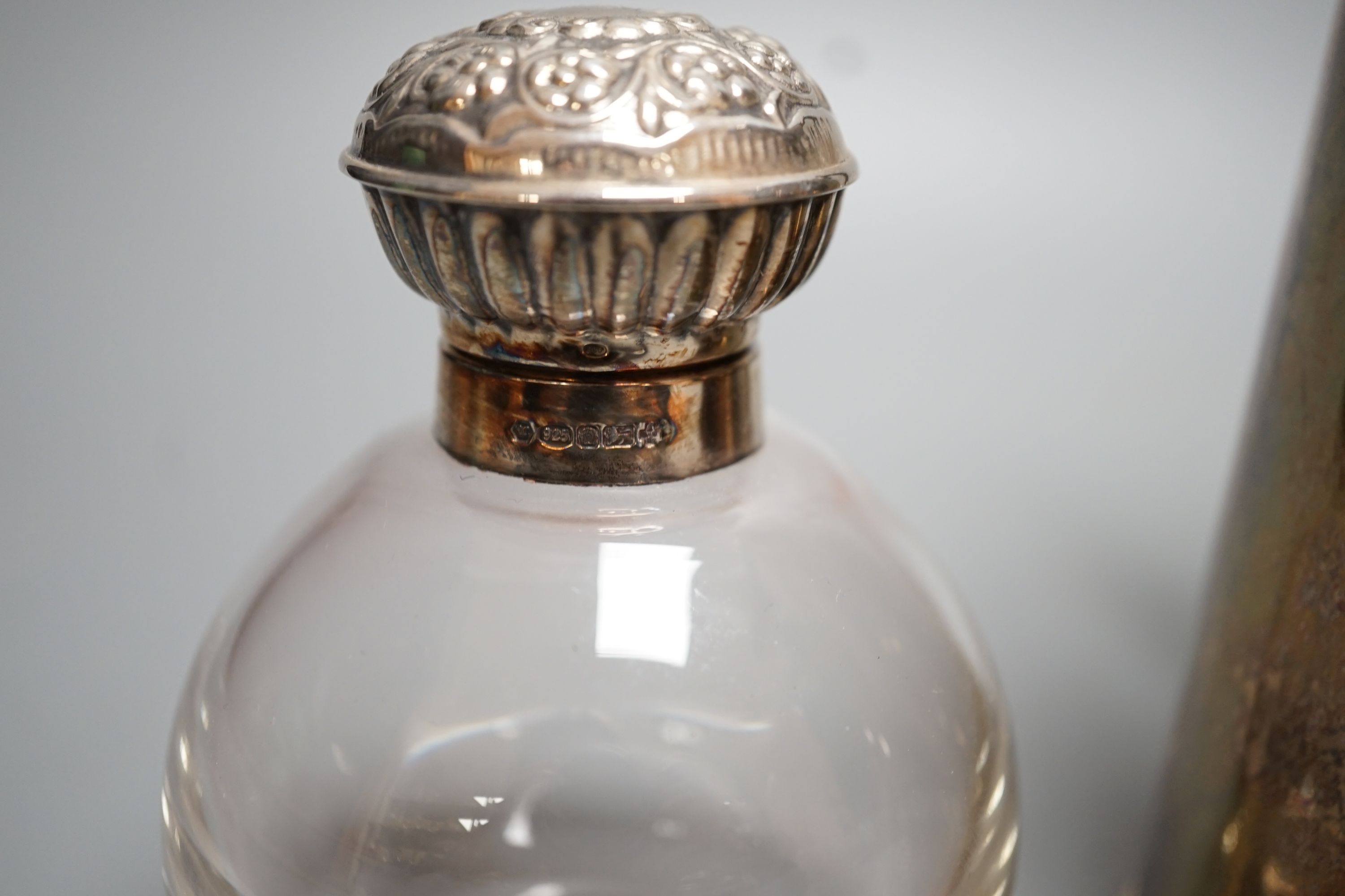 A George V silver hot water pot, London, 1934, gross 15oz and a silver topped glass scent bottle.